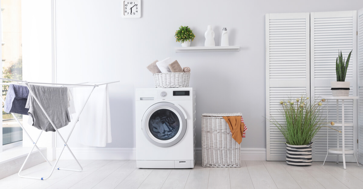Laundry room interior with washing machine near wall